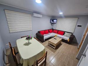 a living room with a table and a couch at Casa con estacionamiento privado in San Carlos