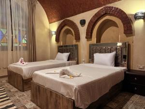 En eller flere senge i et værelse på Saray ElOmda Wellness - Retreat Village