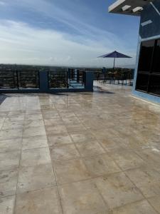 a patio with an umbrella on top of a building at Hillzone View in Kingston