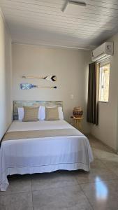 Ένα ή περισσότερα κρεβάτια σε δωμάτιο στο Pousada Bella Brisa