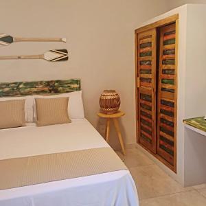 Ένα ή περισσότερα κρεβάτια σε δωμάτιο στο Pousada Bella Brisa