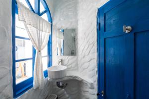 a bathroom with a blue door and a sink at Sweett Lemon Home in Patong Beach