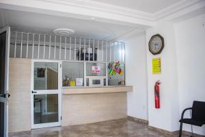 a room with a shelf and a clock on a wall at Hotel Mboloani in Lomé +34 photos