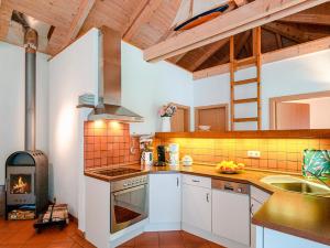 a kitchen with a stove top oven next to a fireplace at Ferienhaus Lenz am Plauer See in Lenz
