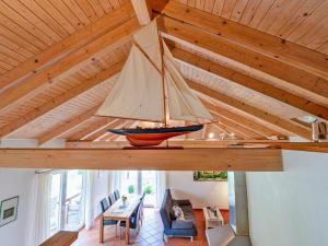 a sailboat hanging from the ceiling of a house at Ferienhaus Lenz am Plauer See in Lenz +14 photos