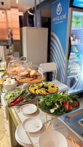 a buffet with many plates of food on a table at Baiterek Сарайшык 40 in Astana