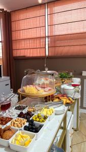 a buffet line with many different types of food at Baiterek Сарайшык 40 in Astana