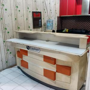 a wooden counter top in a kitchen at Nusantara Center Point By Reccoma in Kayuringin +8 photos