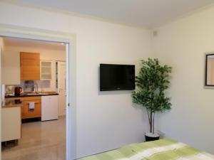 a living room with a tv on a white wall at Appartment Graz Zentrum in Graz