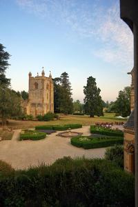 an old building with a garden in front of it at Ettington Park Hotel, Stratford-upon-Avon in Stratford-upon-Avon
