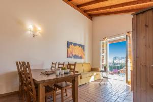 a living room with a table and a couch at Residence Alice in Dormelletto
