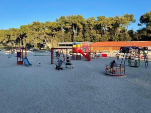 a playground with people playing in the sand at Mobil home Katka in Biograd na Moru