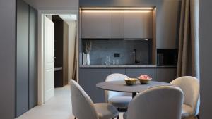 a kitchen and dining room with a table and chairs at Be Mate Citylife in Milan +24 photos