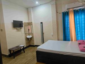 Ένα ή περισσότερα κρεβάτια σε δωμάτιο στο Hotel Ganapati Bhawan +2 φωτογραφίες