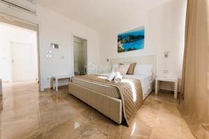 a bedroom with a bed in a white room at Artemar in Porto Cesareo