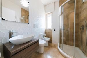 a bathroom with a sink and a toilet and a shower at Artemar in Porto Cesareo