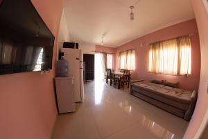 a living room with a couch and a refrigerator at Residencial Beija-Flor in Palhoça