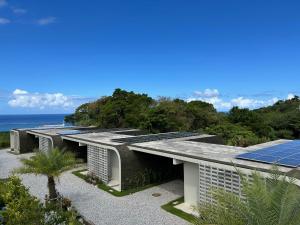 an exterior view of a building with solar panels at ERUMAYA Resort in Motobu