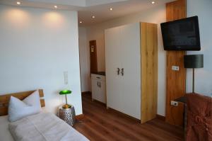 a hotel room with a bed and a tv at Wohnfakturei in Augsburg