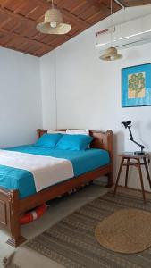 a bedroom with a bed and a table with a lamp at Aqua Vista Studio Appartment in Tangalle