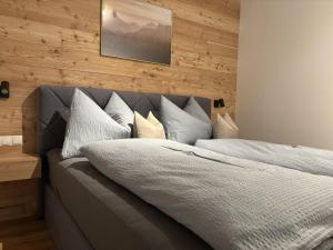 a bedroom with a bed with white sheets and pillows at Apartment Bichlhof in Brixen im Thale