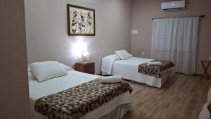 a hotel room with two beds and a window at Posada de Campo San Cono in Mercedes +60 photos