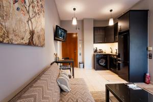 a living room with a couch and a kitchen at Nero Apartment in Agrinion