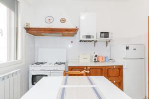 a kitchen with white appliances and a table in it at Apartment with Free Parking Easy Access to Venice in Mestre