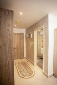 a bathroom with a shower and a rug on the floor at Accra Luxury Apartments at The Bantree in Accra