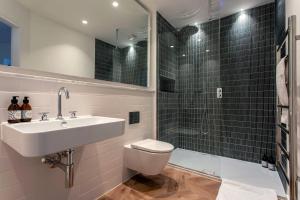 a bathroom with a toilet and a sink and a shower at St James Central Splendor in Bath