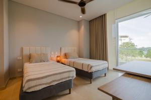 a bedroom with two beds and a large window at 2BR apartment with balcony and amazing views in Pendales +38 photos