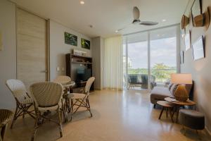 a living room with chairs and a table and a couch at 2BR apartment with balcony and amazing views in Pendales