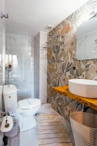 a bathroom with a toilet and a sink at Nero Apartment in Agrinion +27 photos