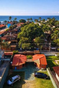 an aerial view of a city with houses and the ocean at Pousada Nusa Dua Maresias in Maresias