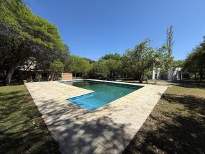 a swimming pool in the middle of a yard at Poseidon in Las Chacras (La Paz)