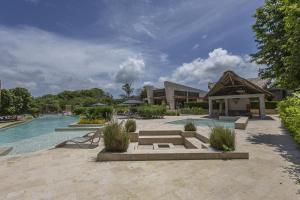 a resort with a swimming pool and a building at Modern apt with 2 BR BBQ and views in Pendales