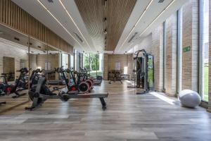 a gym with treadmills and elliptical machines at Modern apt with 2 BR BBQ and views in Pendales