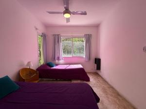 a bedroom with two beds and a window at Poseidon in Las Chacras (La Paz)