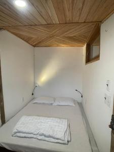 ein Bett in einem Zimmer mit Holzdecke in der Unterkunft Nhà Sen Phước Hải in Hội Mỹ