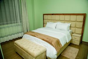 Postel nebo postele na pokoji v ubytování Mercella Homes - Munyonyo