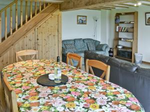 a dining room table with a flower blanket on it at Robin in Flamborough +6 photos