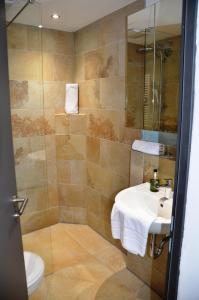 a bathroom with a sink and a shower at Wohnfakturei in Augsburg +4 photos