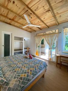 een slaapkamer met een bed en een plafondventilator bij Casa Aquila Mazunte in Mazunte +47 foto's