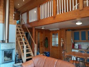 a living room with a staircase in a cabin at Yläkolo - A functional cottage in a good location in Saariselka