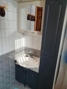 a bathroom with a sink and a mirror at Yläkolo - A functional cottage in a good location in Saariselka +30 photos