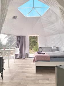 a bedroom with a bed in a white tent at Bubble House glamping tent Odulemma 