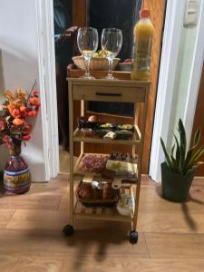 a wine cart with wine glasses and food on it at Tropical Room in Brussels