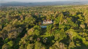 an aerial view of a house in the middle of a forest at Mountain view villa heated pool Nyeri - 2352 in Kuhora Twana