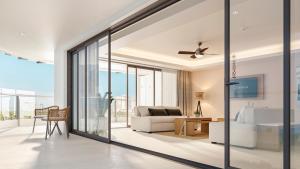 een woonkamer met glazen deuren en een bank bij Sunset Plaza Beach Resort Puerto Vallarta All Inclusive in Puerto Vallarta
