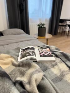 a book sitting on top of a bed at Cozy Center Apartment in Jelgava